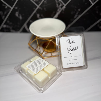 Two wax melts in packaging with a label on a white surface.